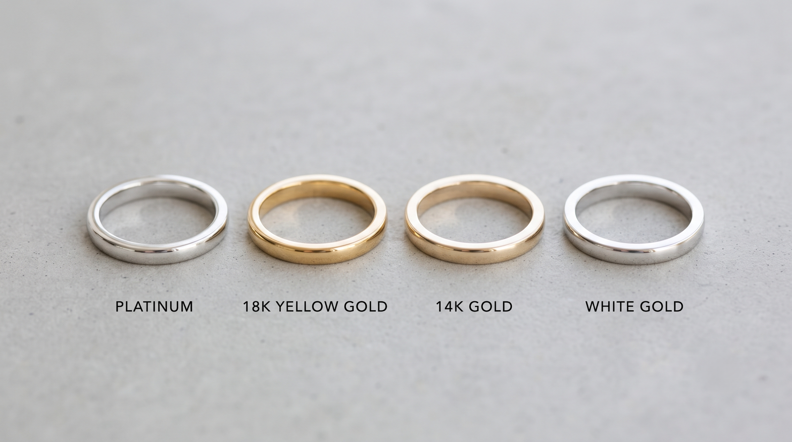 Four ring shanks in platinum, 18k yellow gold, 14k gold and white gold laid in a row