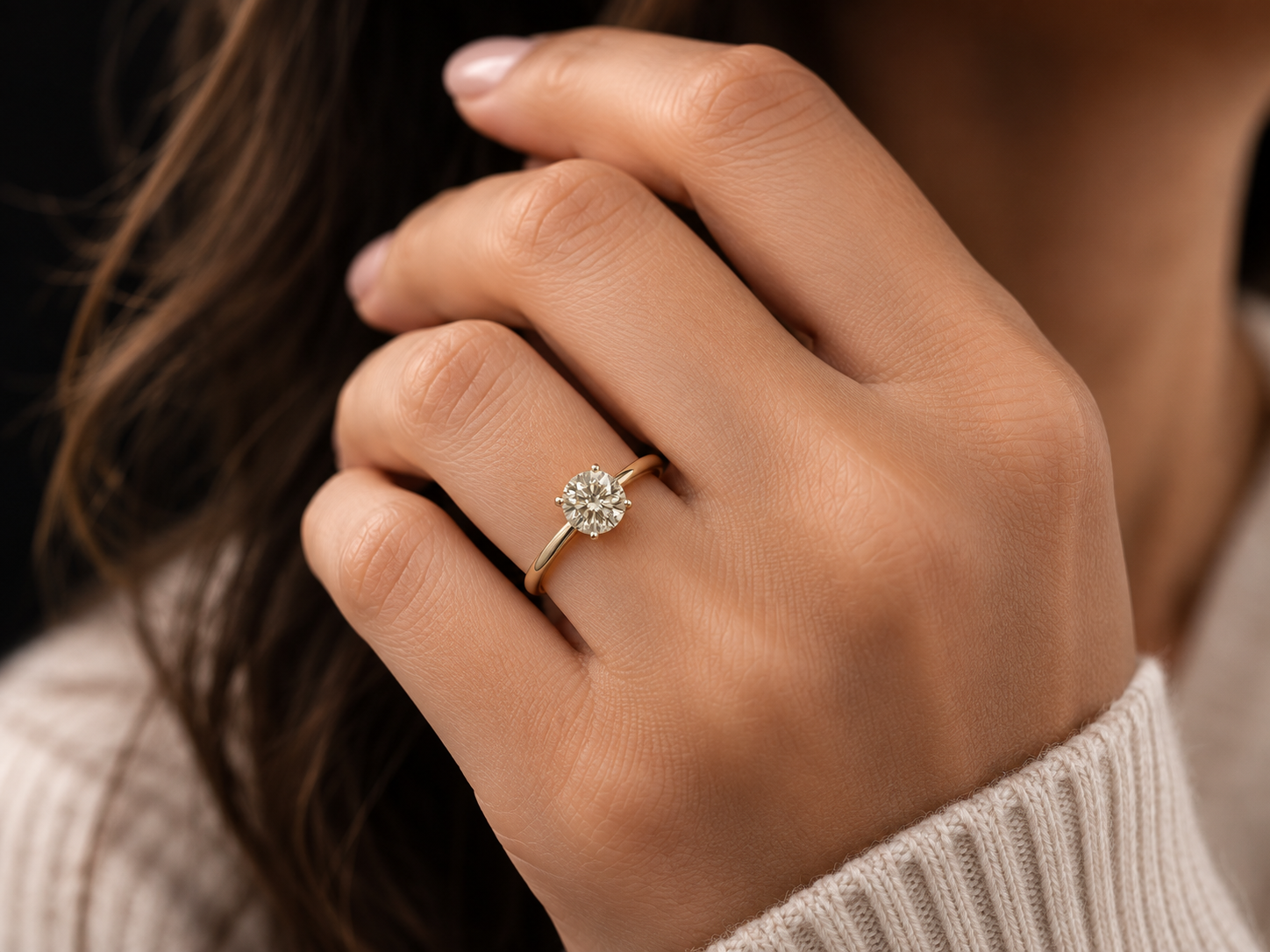 Memorial diamond set in a ring worn on a hand, showing the everyday scale of the stone 