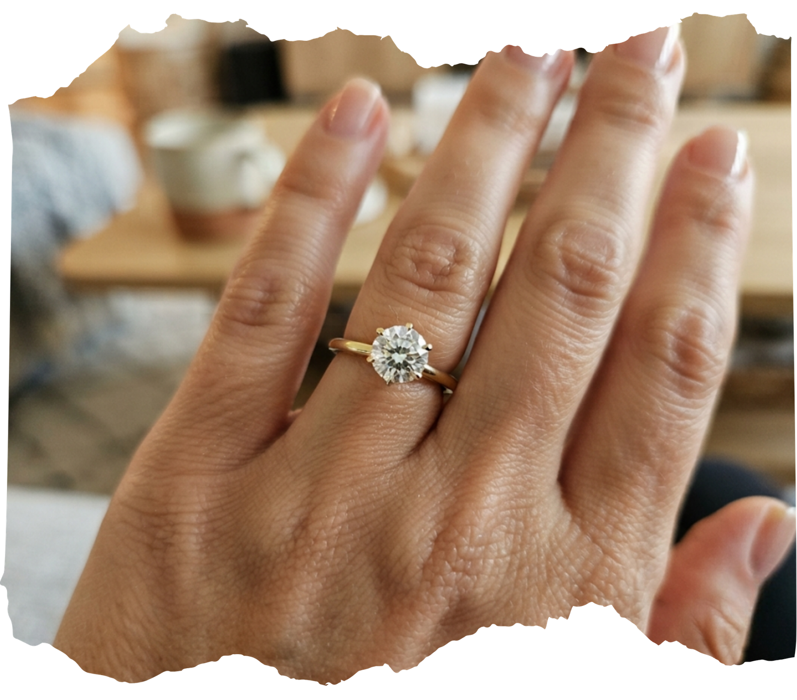 A brilliant cut memorial diamond set in a classic gold solitaire ring worn on a finger, shared by customer Sarah M.